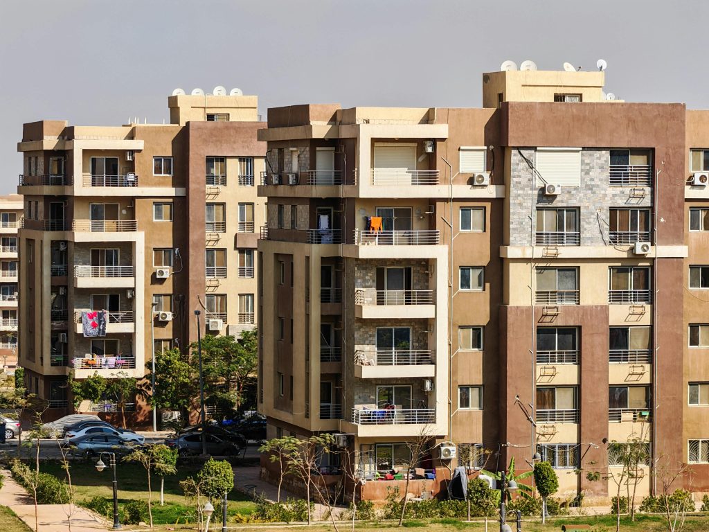 Contemporary multi-story apartment buildings in a sunny urban environment.